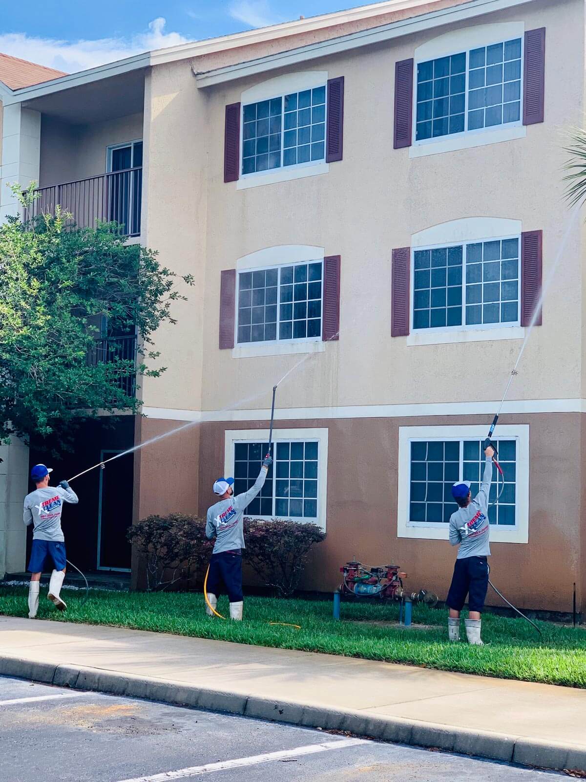 A crew of men powerwashing a building